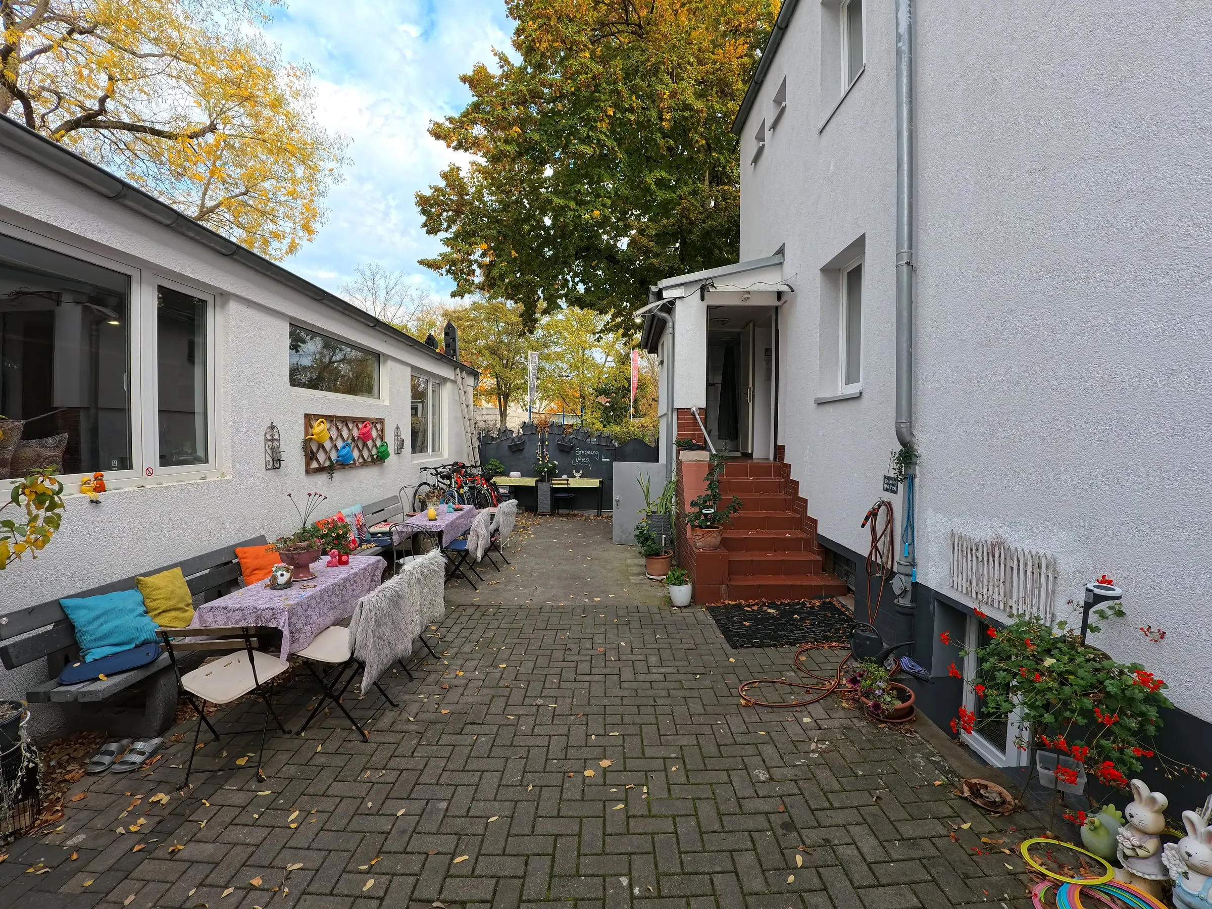 Der Innenhof mit gedeckten Tischen, Bänken und bunten Kissen